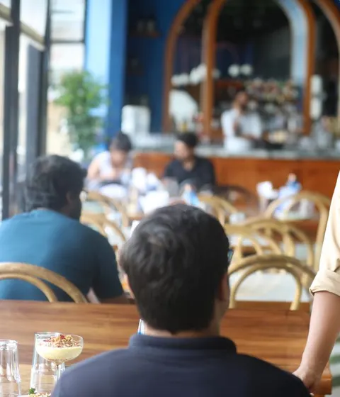 A café host talking with a guest in Bengaluru